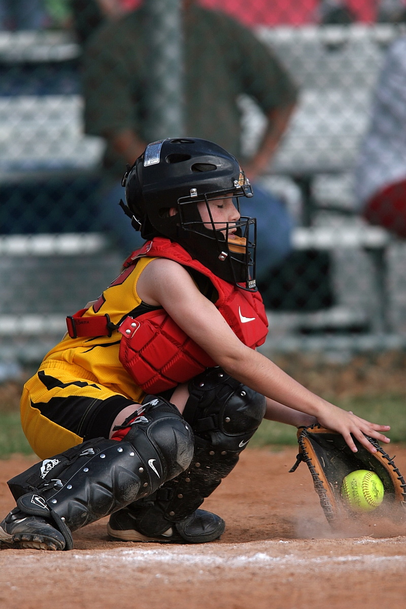 sports helmet, game, day, competitive, player, focus on foreground, motion, catchers mitt, catcher, softball, people, catchers mask, girl, outdoors, holding