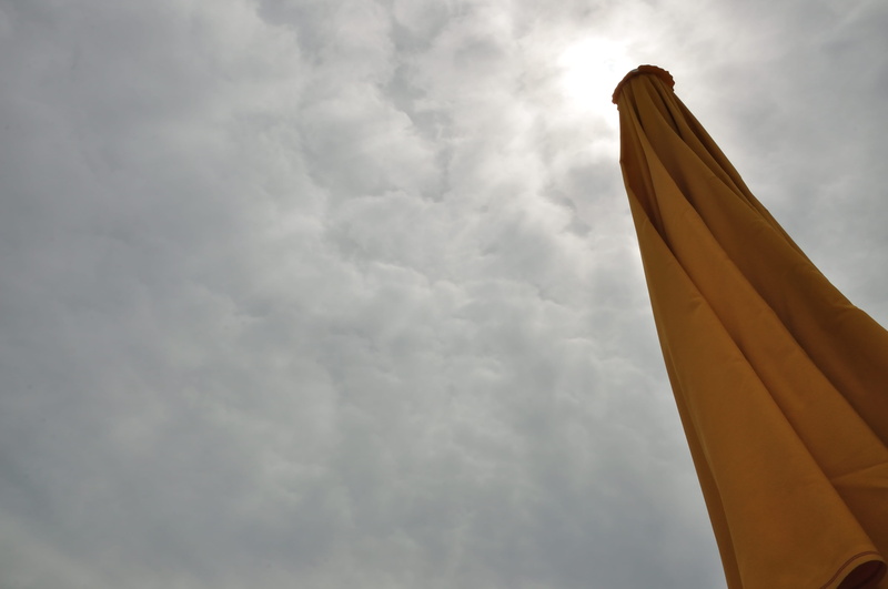 nature, umbrella, city, overcast, history, memorial, low angle view, beach, travel, beauty in nature, architecture, outdoors, transportation, sky, ominous