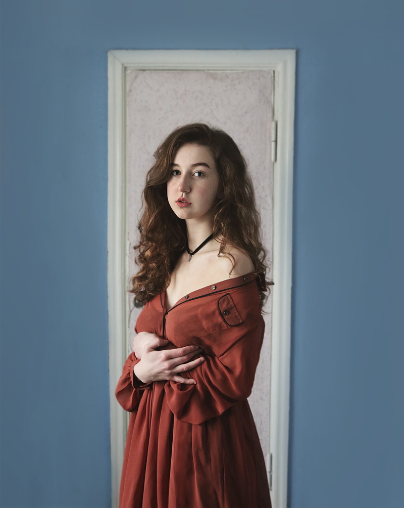 portraiture, door, look, standing, looking at camera, person, women, long hair, clothing, design, blue, curlyhair, young adult, classic, one person, indoor