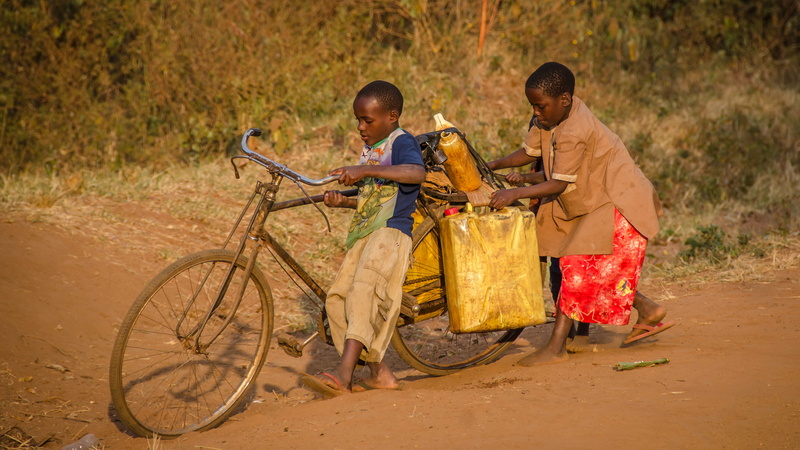 brown, wheel, people, apparel, lifestyles, men, boys, vehicle, offspring, bicycle, family, transportation, uganda, sport, road, togetherness, outdoors