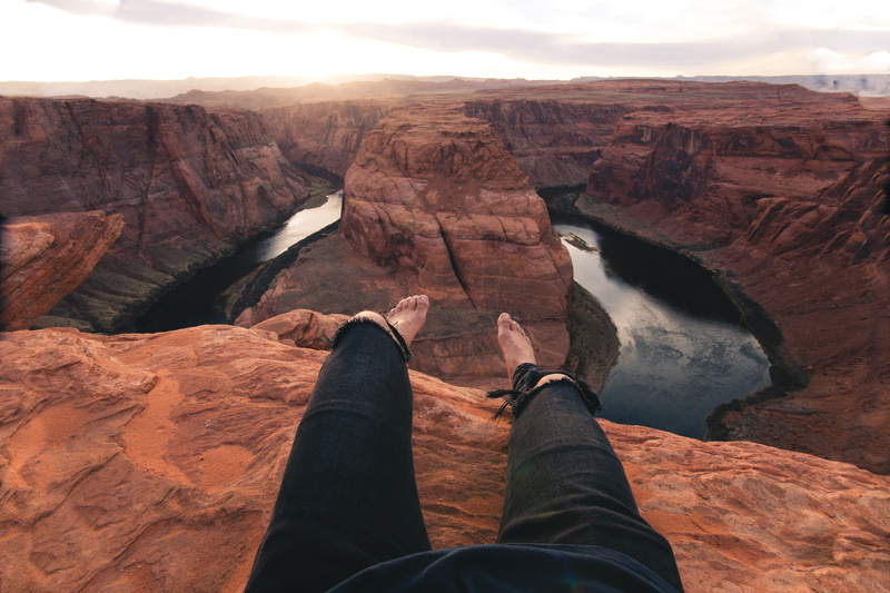 unrecognizable person, wanderlust, mountain range, personal perspective, non-urban scene, nature, beauty in nature, human leg, real people, horseshoe bend
