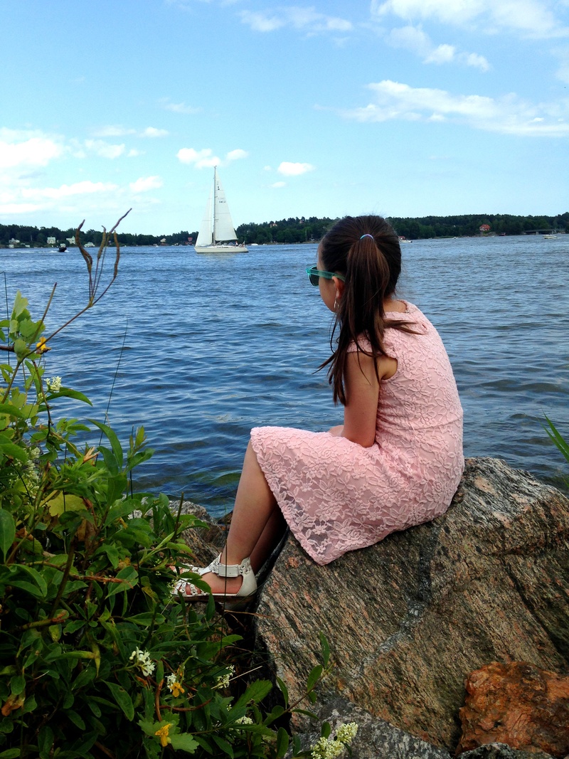 sitting, nature, water, long hair, outdoors, looking at view, real people, women, one person, cloud - sky, lifestyles, hairstyle, sailboat, leisure activity