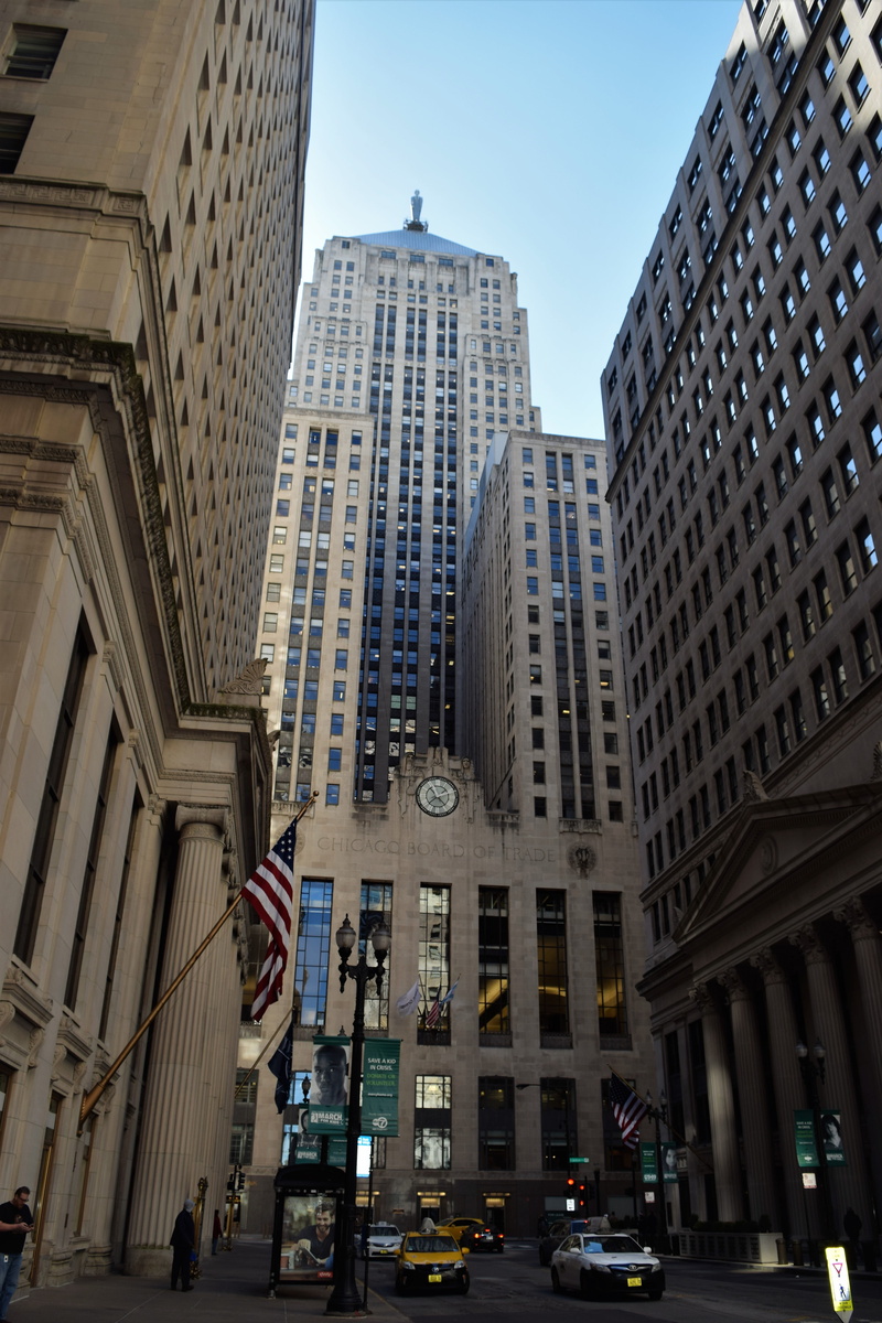 transportation, mode of transportation, city life, downtown, flag, art deco, office, street, car, road, urban, landmark, built structure, skyscraper, building