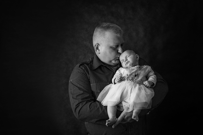 love, daughter, innocence, baby, positive emotion, holding, studio shot, black background, care, dad, child, people, beginnings, softness, adult, babyhood