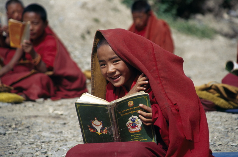 boy, reading, happiness, looking at camera, togetherness, outdoors, day, 5K, leisure activity, traditional clothing, happy, emotion, red, people, holding