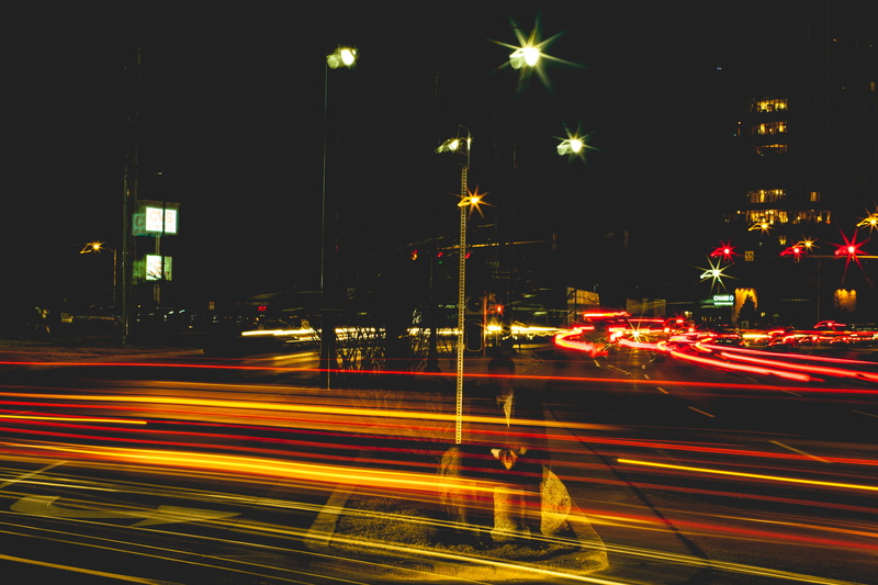street light, city life, night, building exterior, suit, traffic, street, vehicle light, built structure, mystery, speed, transportation, light trail, united states