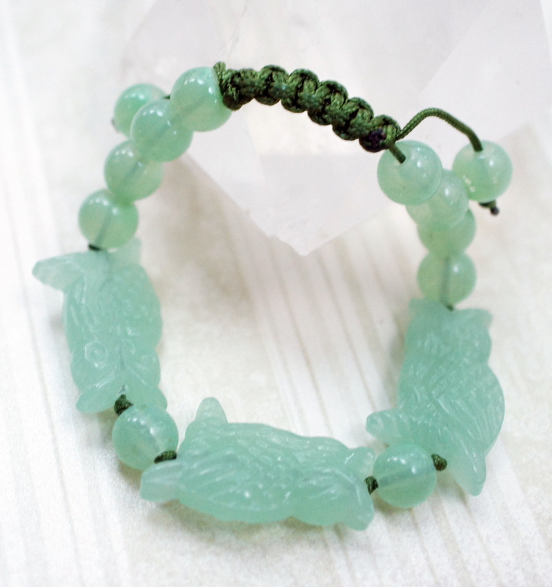 aventurine, no people, plant part, stone, white color, decoration, crystal, bracelet, owl, gemstones, green, nature, green color, selective focus, indoors
