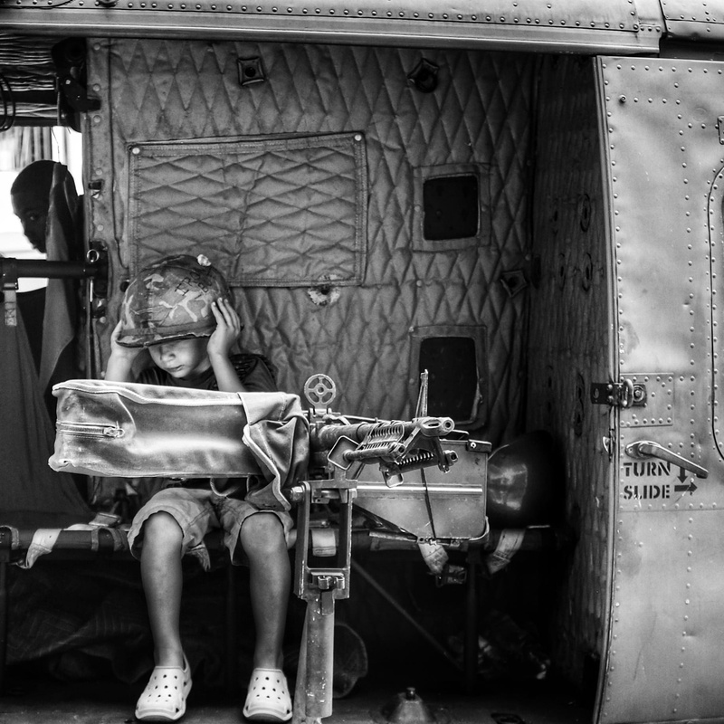 helicopter, boynton beach, 720P, day, vietnam, men, childhood, one person, full length, memorial, sitting, veteran, males, child, front view, war machine