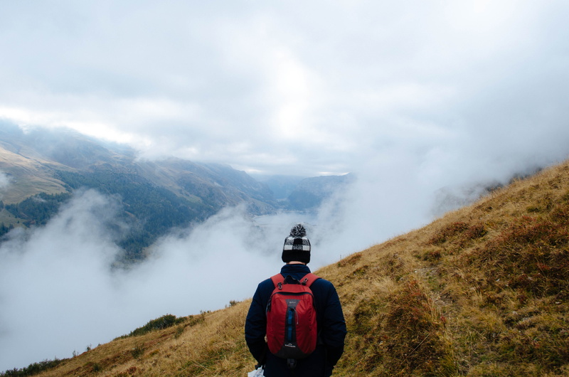 man, landscape, mist, environment, misty, male, leisure activity, tree, standing, hill, beauty in nature, day, activity, tigne, nature, sky, cloud, bag