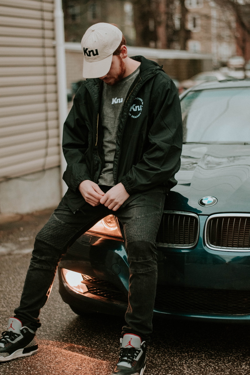 building, near, jacket, casual clothing, front view, young adult, vehicle, bmw, mode of transportation, day, brown, 5K, real people, hood - clothing, man