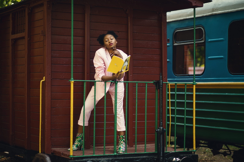 real people, heeled, vehicle, magazine, public transportation, females, one person, train, lifestyles, pink, covered, modelling, leisure activity, photoshoot