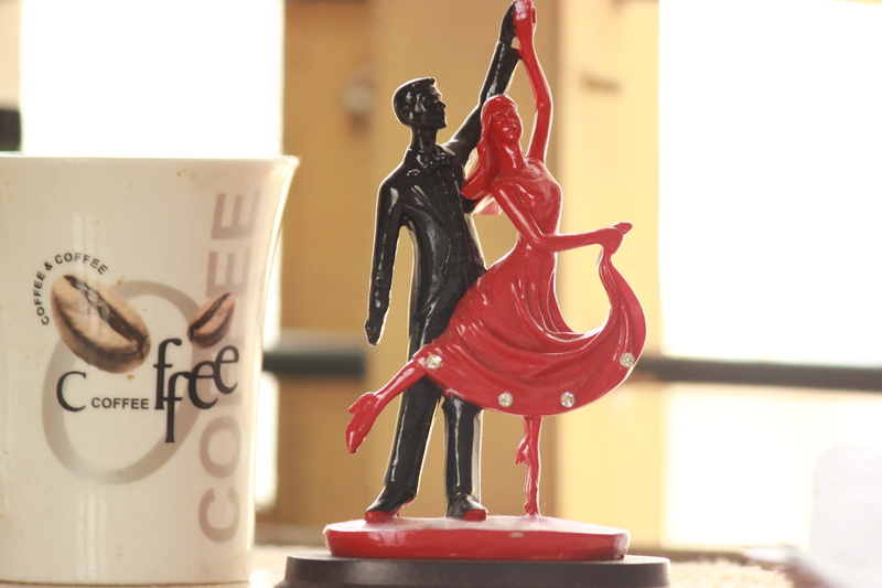 focus on foreground, art and craft, food and drink, toy, day, close-up, couples, female likeness, cofee, text, creativity, food, indoors, representation