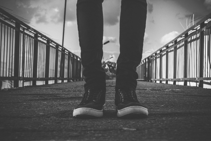 architecture, railing, human limb, 5K, one person, human foot, day, black, human leg, bridge, surface level, limb, built structure, human body part, center