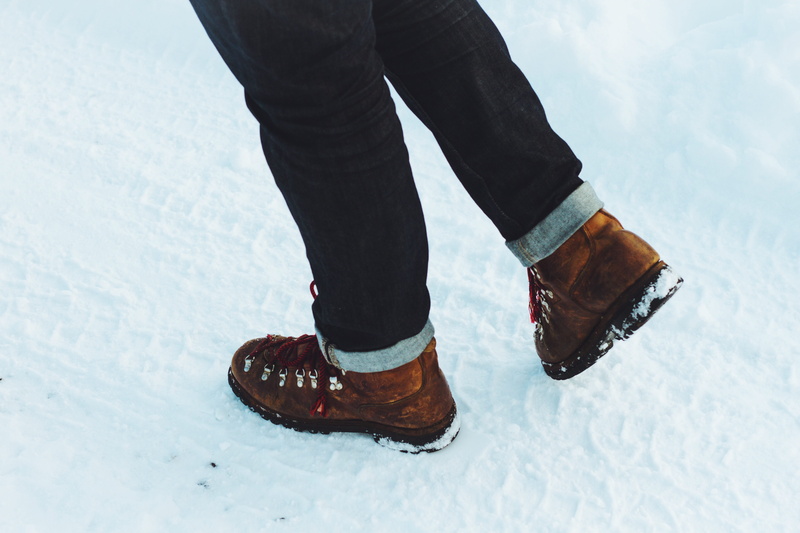 leisure activity, black, fashion, day, human foot, limb, lifestyles, outdoors, snow, clothing, human body part, cold temperature, walking, boot, groiund