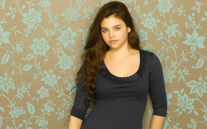indoors, earring, standing, young adult, India Eisley, floral pattern, hairstyle, pattern, wall - building feature, beautiful woman, one person, beauty