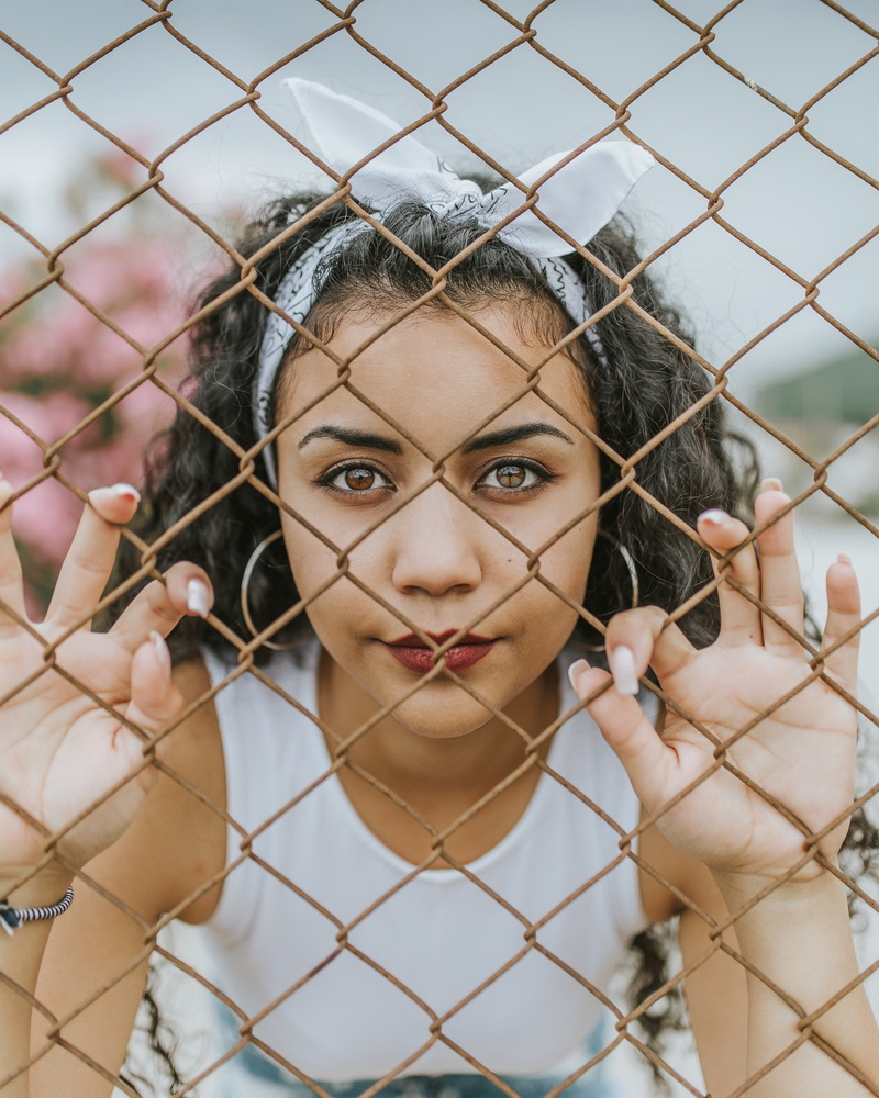 one person, portrait, boundary, beautiful people, body part, fence, young women, women, brunette, barrier, hair, headshot, chainlink fence, looking at camera