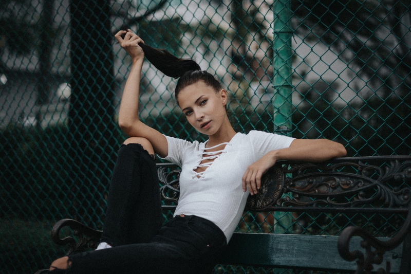 outdoors, chainlink fence, looking, leisure activity, women outdoors, 720P, standing, barrier, bench, casual clothing, fence, hairstyle, young women, one person