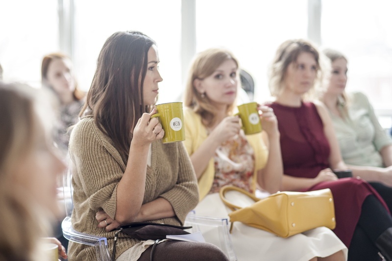 wearing, mug, food and drink, friendship, young women, woman, leisure activity, talking, corduroy, lifestyle, holding, indoors, lifestyles, wear, sitting