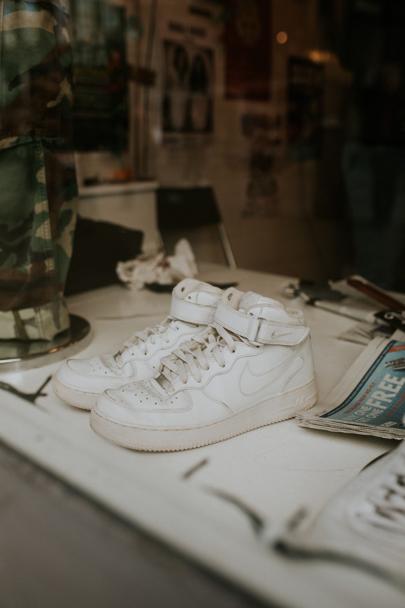 indoors, no people, nike, relaxation, creativity, publication, shoe, table, white, shoes, close-up, focus on foreground, air, book, selective focus, still life