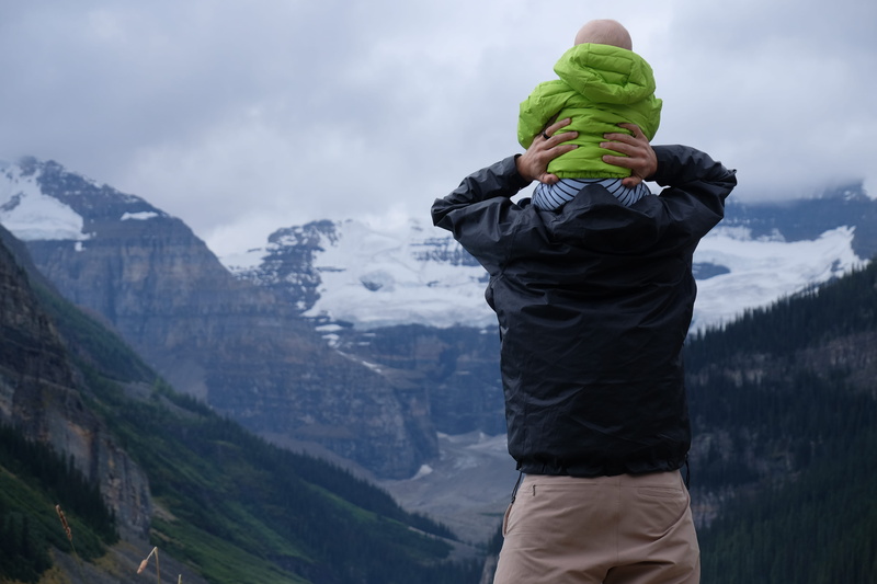 standing, men, tree, sky, warm clothing, person, woodland, baby, mountain range, real people, top, mountain, day, leisure activity, outdoors, scenics - nature