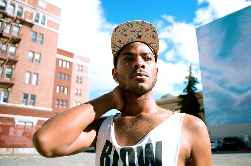 strength, woman, sky, men, top, sport, tank top, adult, young adult, lifestyles, attitude, front view, style, cloudy, cloud, hat, city, blue, outdoors