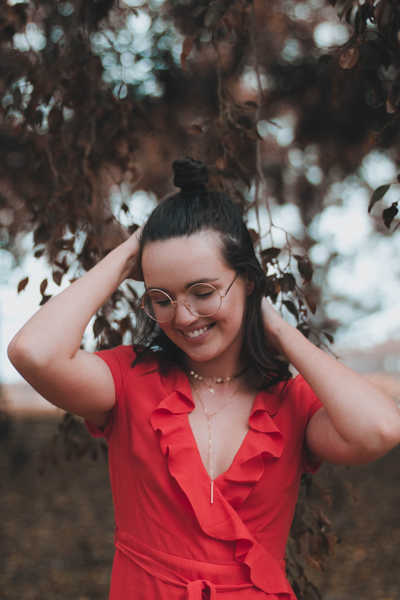 gold, women, red, putting, leisure activity, looking at camera, smiling, arms, warm, real people, v, daytime, outdoors, front view, hairstyle, focus on foreground