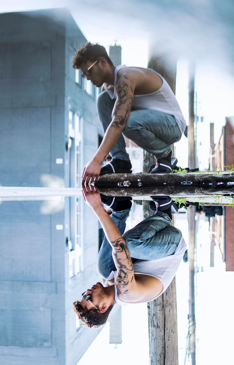 touch, glass, outdoors, standing, reflect, built structure, casual clothing, day, building exterior, architecture, fashion, people, reflection, wearing