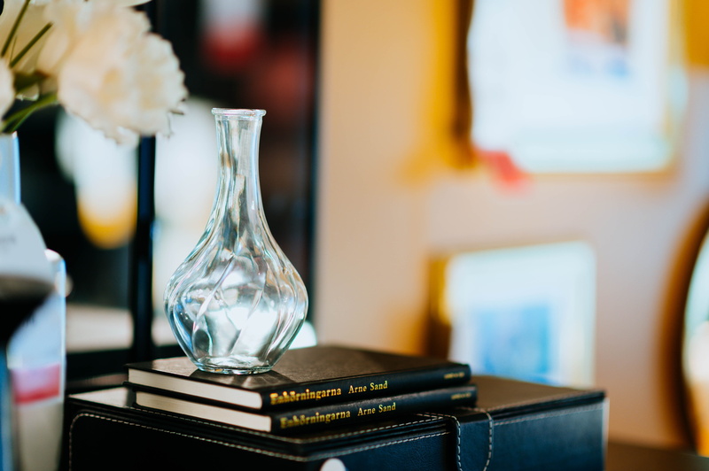 home decor, close-up, publication, flower bouquet, file binder, clear, flower arrangement, container, table, goblet, paper, bottle, pottery, business, focus on foreground