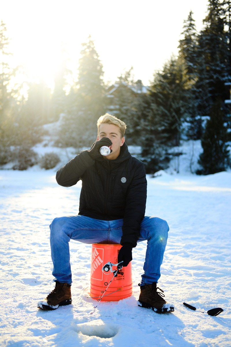 pants, apparel, jeans, one person, cap, real people, flare, sleeve, sitting, daytime, bucket, leisure activity, snow, light, orange, clothing, ski boot