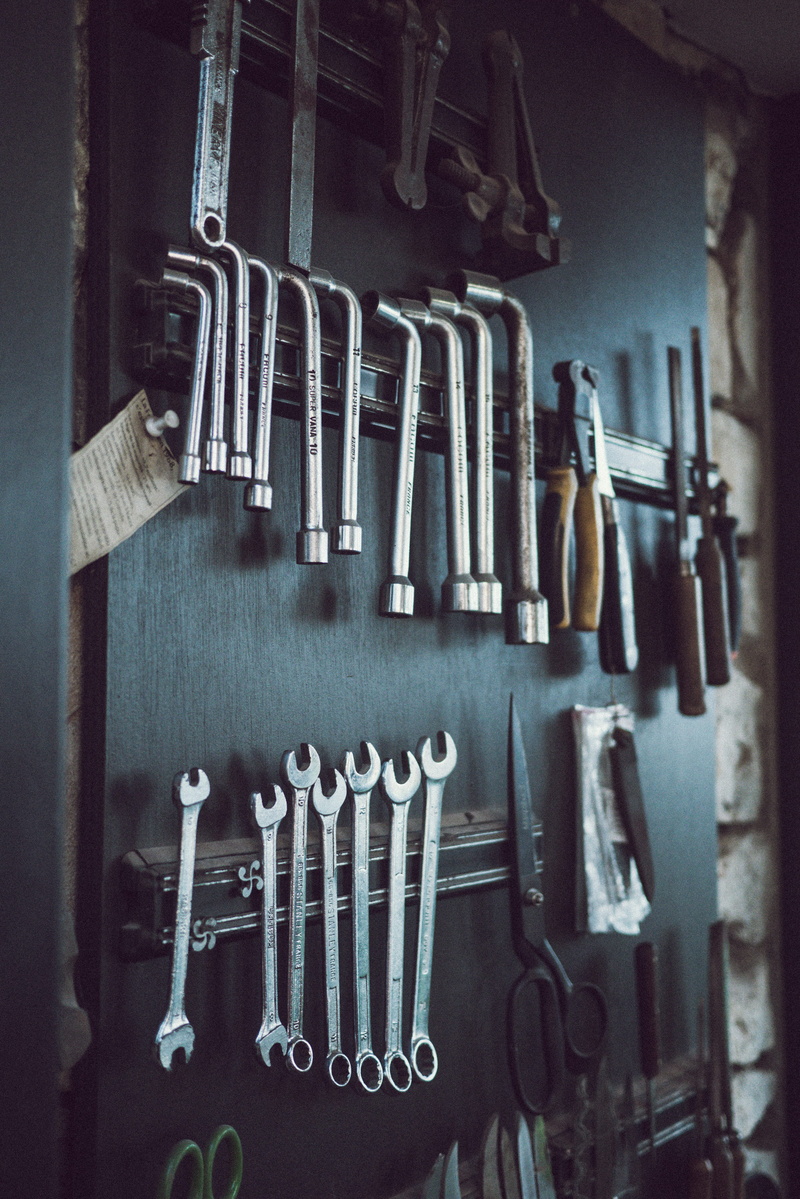 axe, work tool, indoors, tool, can opener, plumbing, group, shelf, equipment, wall, text, hand, close-up, hand tool, hanging, snow, assorted, clamp, footwear
