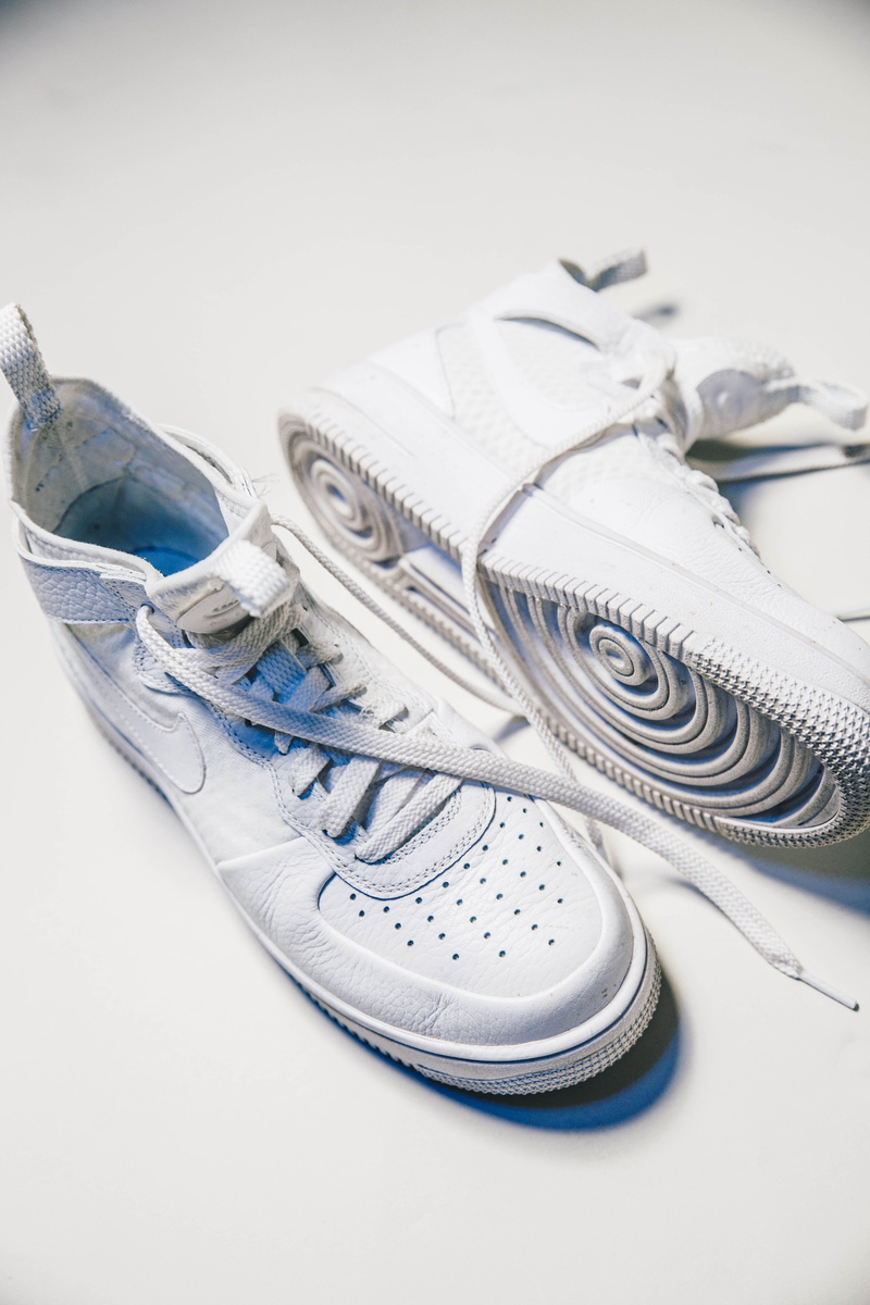 focus on foreground, outdoors, land, white color, nike, spoke, studio, indoors, sand, paper currency, wealth, finance, sneaker, close-up, footwear, high angle view
