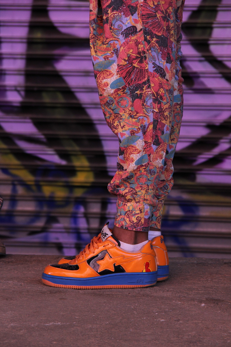 focus on foreground, fashion, hype, top, women, balance, multi colored, blue, body part, human leg, colorful pant, no face, colorful shoe, low, bright