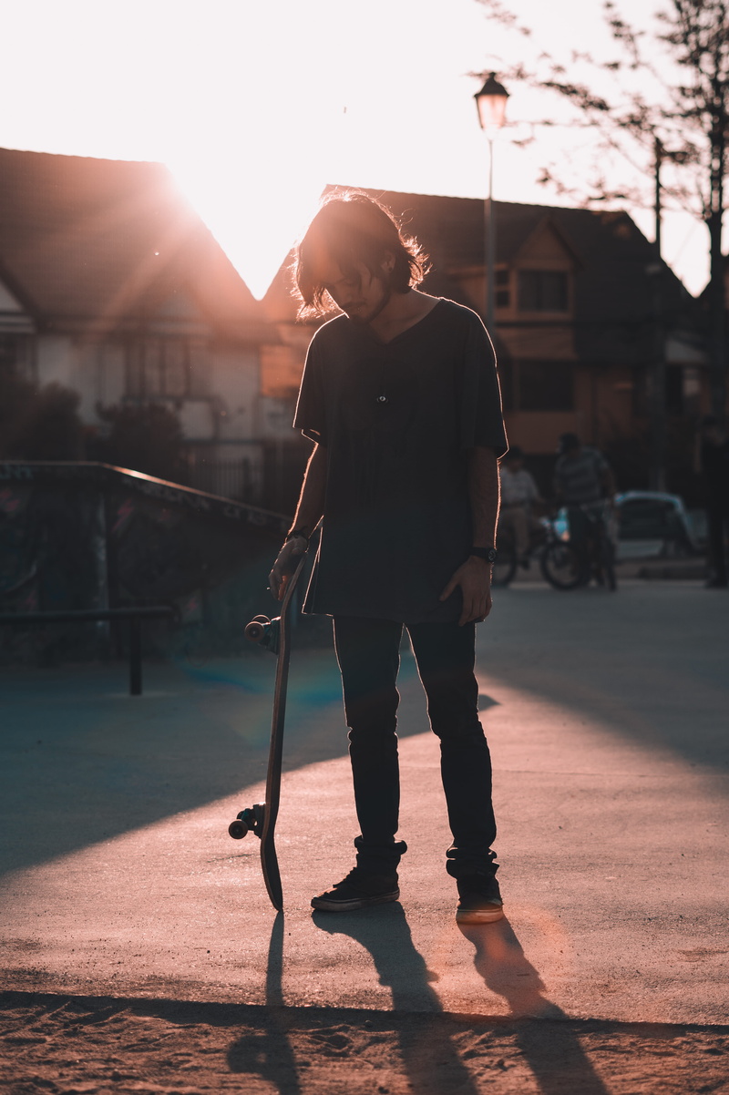 casual clothing, sunlight, skateboarding, city, leisure activity, one person, skate, outdoors, 5K, real people, architecture, man, lens flare, sky, street