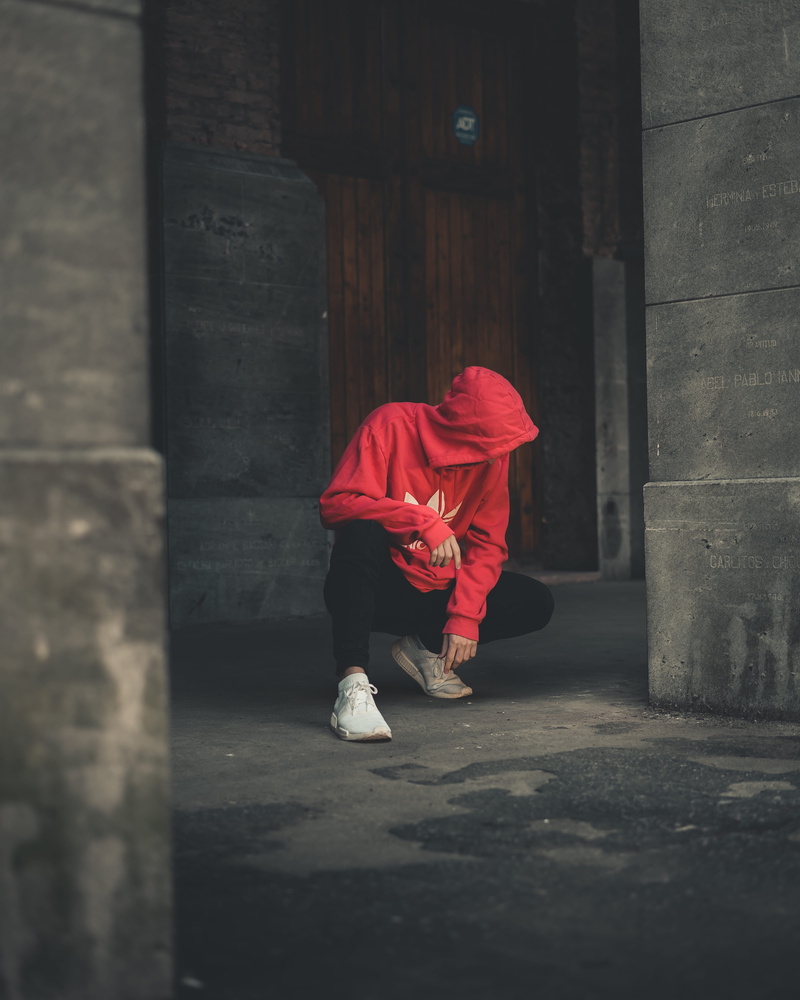 sitting, model, photoshoot, walking, person, man, rubber shoes, sneakers, posture, belief, leisure activity, architectural column, rear view, red, real people