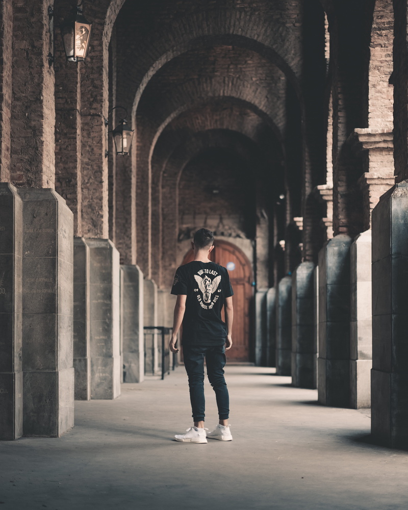 blur, building, pose, day, concrete wall, casual clothing, focus, built structure, 4K, black shirt, rear view, real people, hallway, wearing, guy, photo
