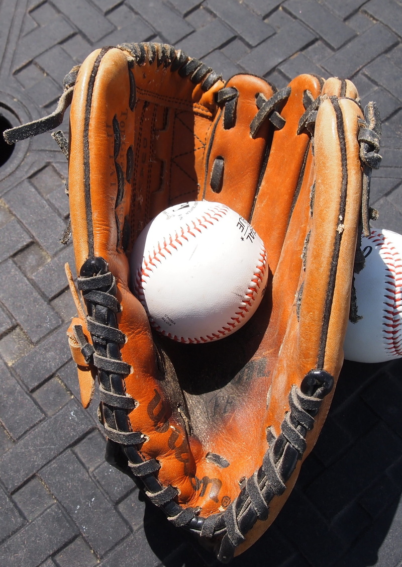 2K, no people, equipment, wood - material, sports, day, orange color, ball, mitt, baseball glove, high angle view, team sport, still life, outdoors, leather