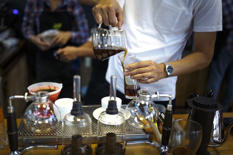 cup of coffee, pouring, table, holding, preparation, container, drink, man, one person, bar, person, real people, espresso, restaurant, liquid, food and drink