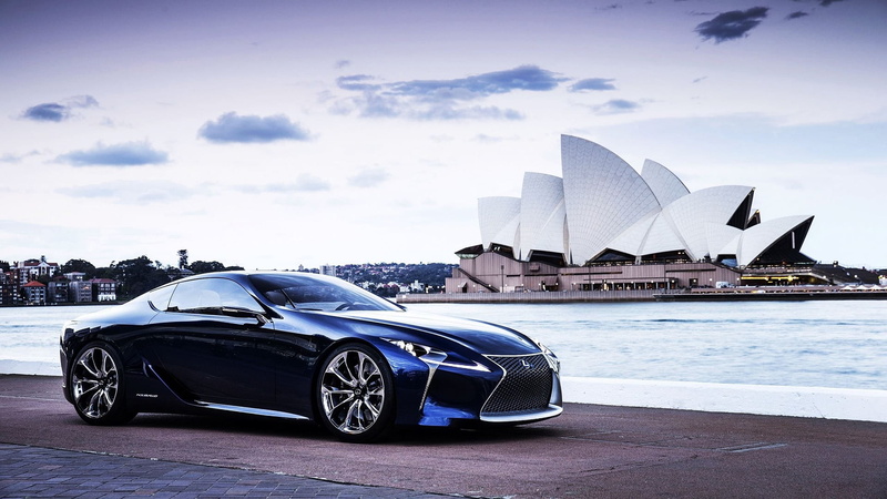 arts culture and entertainment, skyscraper, sports car, city, drive, speed, water, building exterior, white color, built structure, architecture, office building exterior