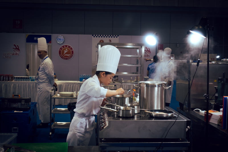 uniform, food, illuminated, people, chef, kitchen, preparing food, real people, working, three quarter length, standing, food and drink, men, adult, food and drink establishment