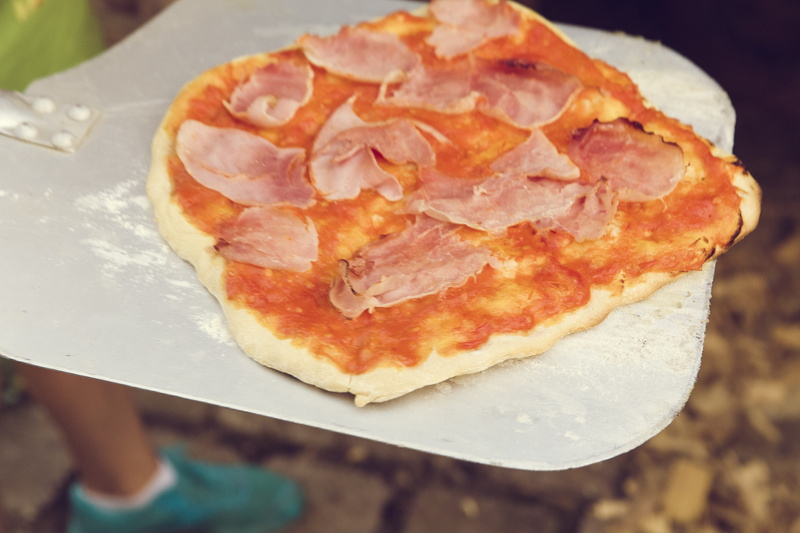 wood, pizza maker, high angle view, wood burning stove, human hand, ready-to-eat, freshness, 5K, one person, scalloped, indoors, pizza oven, pizzeria