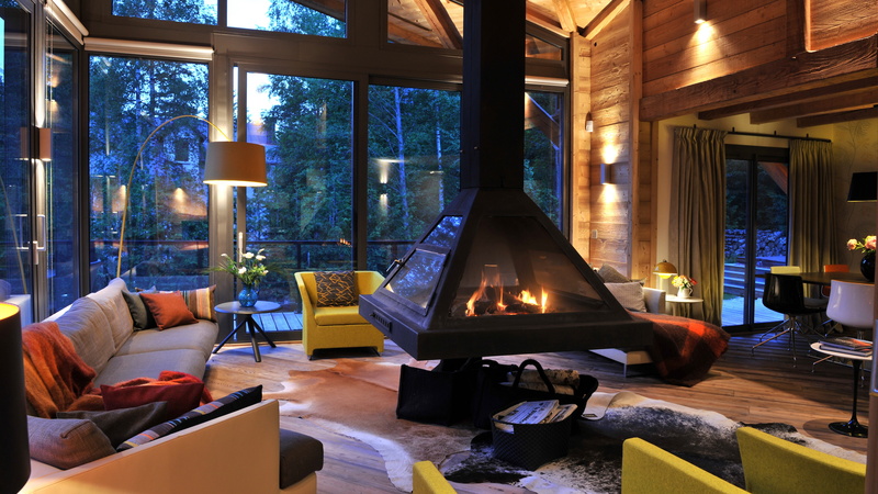 electric lamp, furniture, picture of wood burning stoves in living room, illuminated, window, wealth, indoors, cozy, home interior, seat, luxury, domestic room