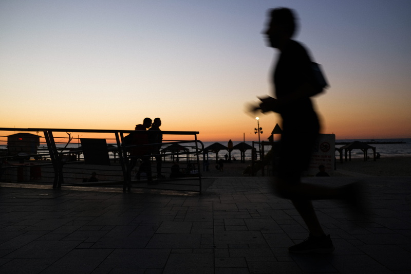 group of people, running, sunset, promenade, beauty in nature, architecture, railing, beach, photography, leisure activity, water, man, person, orange color