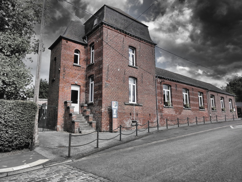 black and white, city, brick, outside, clouds, road, plant, overcast, architecture, cloud - sky, window, building, transportation, isolated color, building exterior