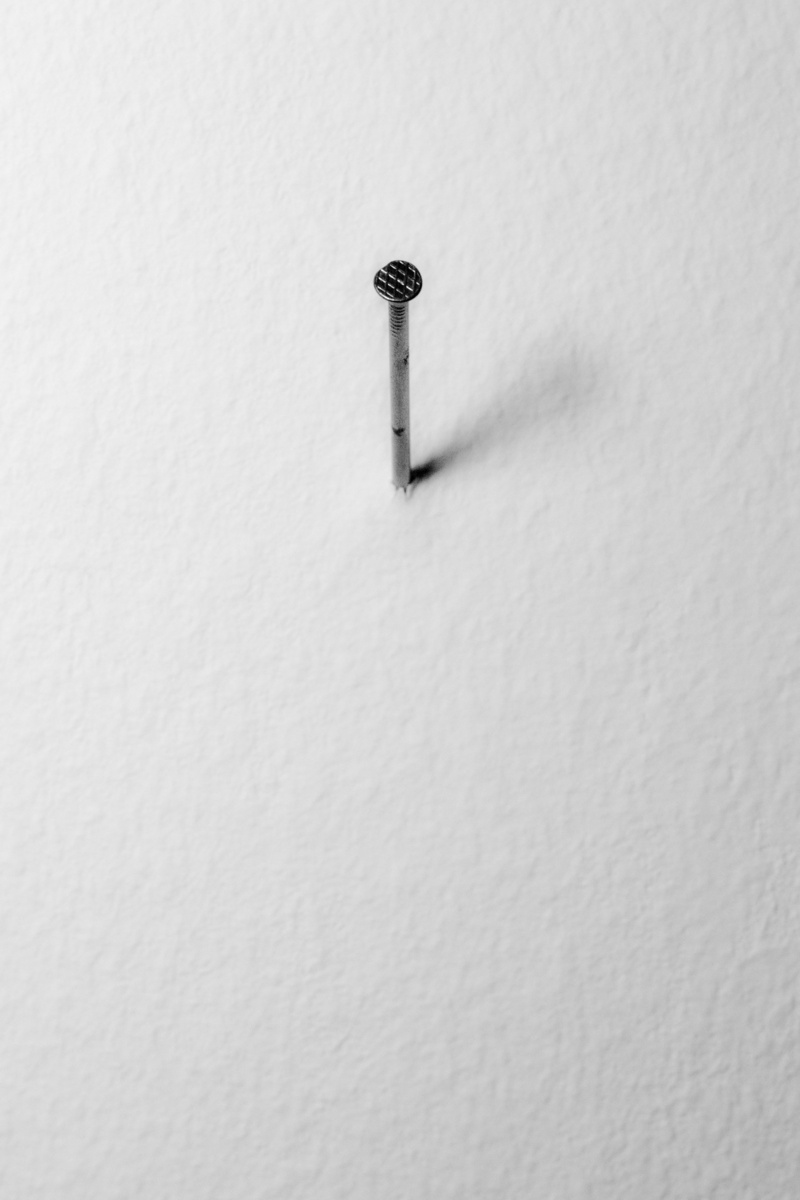 single object, communication, pattern, backgrounds, still life, metal, no people, white color, black and white photography, nail, silver colored, day, stability