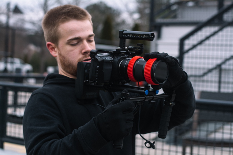 human, outdoors, holding, screen, stabilizer, monitor, nature, 5K, camera - photographic equipment, occupation, pullover, hoodie, photographer, young men