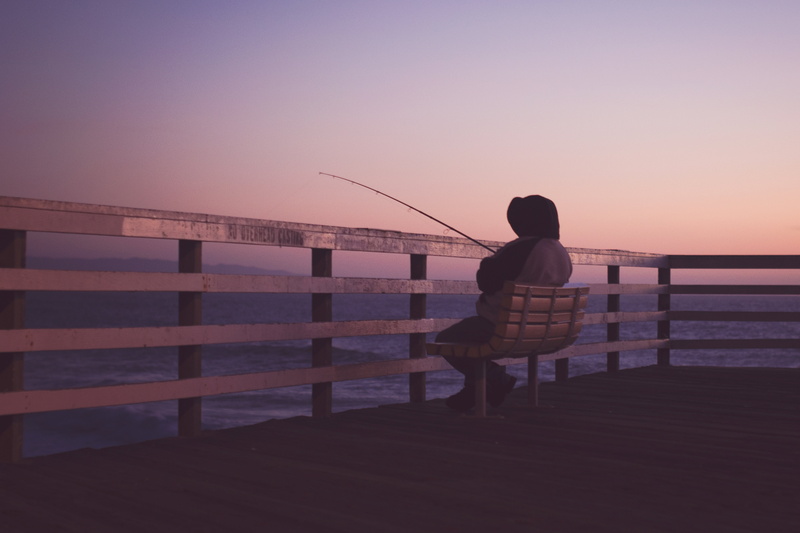 beauty in nature, sunset, one person, beach, holding, hooded, sitting, man, silhouette, people, 5K, rod, sea, outdoors, clear sky, one woman only, twilight