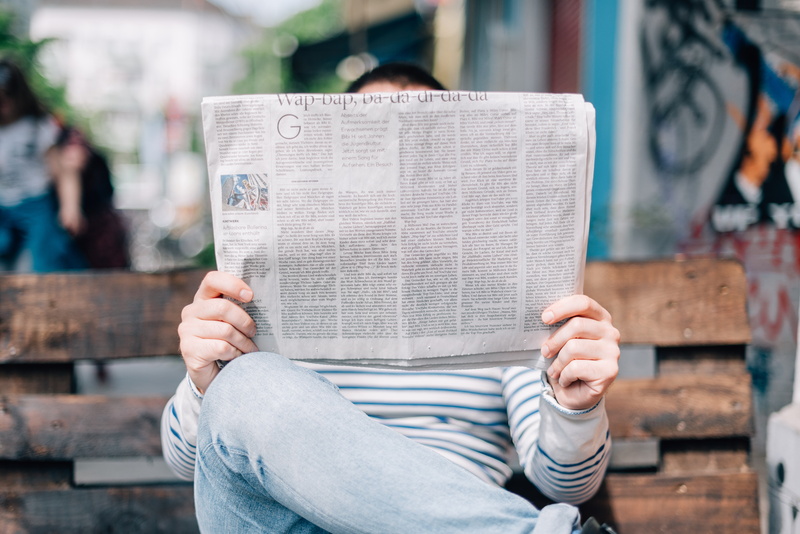 communication, outdoors, activity, 5K, publication, sitting, daytime, newspaper, man, lifestyles, holding, information medium, reading, day, one Person