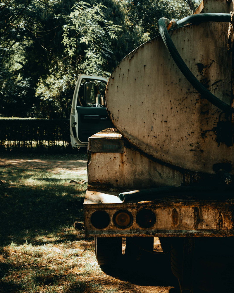 stationary, vehicle, outdoors, abandoned, building, bunker, slate, plant, wood, arecaceae, day, nature, obsolete, transportation, land vehicle, no people