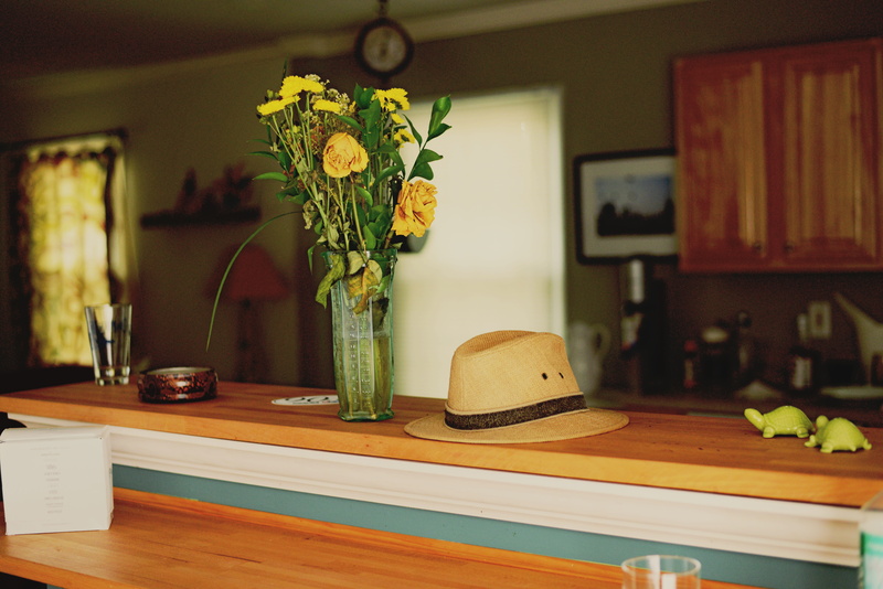 indoors, electric lamp, no people, countertop, hat, flowering plant, wood - material, flowers, kitchen, wood, freshness, home interior, flower arrangement