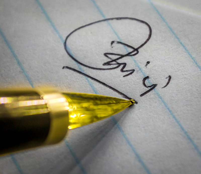 close-up, drawing - art product, paper, autograph, sport, macrolens, writing instrument, high angle view, drawing - activity, sketch, indoors, pen, yellow
